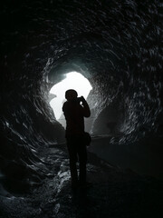 A person photographing inside Katla Ice Cave, Mýrdalsjökull Glacier, South Iceland.
