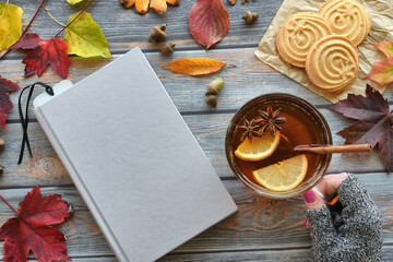 Autumn book cover mock up flat lay with female holding spiced hot tea