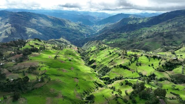 Aereal view of mountains and grasslands in the Andes, Andean or Sierra geographical region of the Peru that extends from north to south through the Cordillera de los andes.