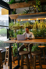 Man working on laptop at cafeteria