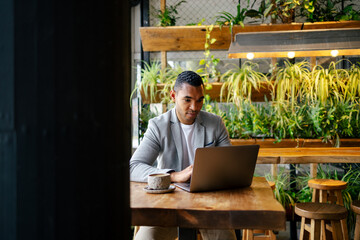 Man working on laptop at cafeteria