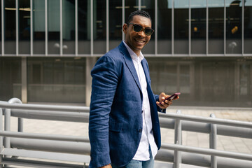 Man walking through financial area with smartphone