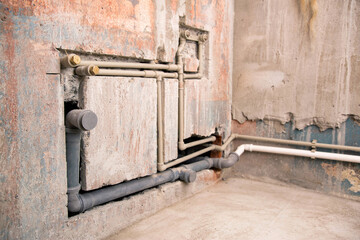 Supply of polypropylene water pipes in the wall and sewerage drain. Copy space for text
