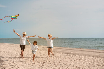 Happy asian family enjoy the sea beach. father, mother and daughter having fun playing beach in summer vacation on the ocean beach. Happy family with vacation time lifestyle concept.