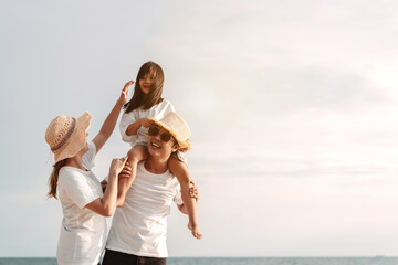 Happy asian family enjoy the sea beach. father, mother and daughter having fun playing beach in summer vacation on the ocean beach. Happy family with vacation time lifestyle concept.