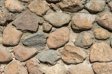 Stone wall. Cobbles various shape. Background close-up.