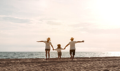 Happy asian family enjoy the sea beach. father, mother and daughter having fun playing beach in...