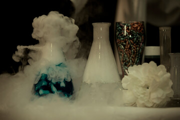 In a chemical laboratory, flasks filled with solutions in smoke.