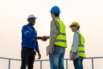 African american technician handshake for teamwork,successful negotiate,hand shake,two Engineer shake hand with partner to celebration partnership and business deal concept