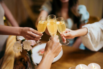 Group of friends celebrating with champagne  Close up on hands.