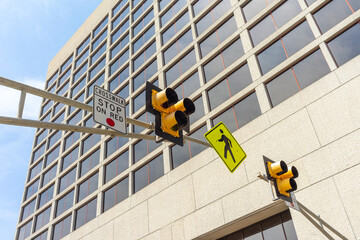 Low angle view of a pedestrian crosswalk traffic signal lights in a city - obrazy, fototapety, plakaty