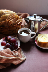 Brazilian breakfast. Coffee and bread with butter, grapes.