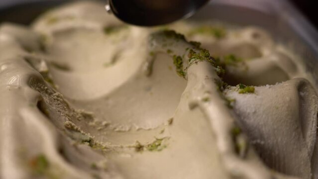 Movement of pistachio ice cream scooped with a special spoon