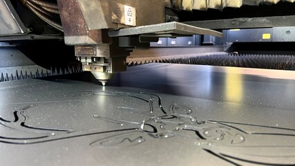 Close up of industrial laser cutter. Laser cutting machine cutting steel plate in factory