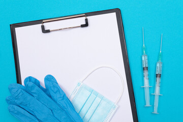 Vaccination, Immunology or Revaccination Concept - Two Medical Syringe Lying on Blue Table in...