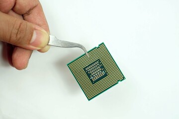 A hand handle the CPU of computer with a attach handle tool.