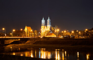bridge over the river Warta and gothic cathedral at night in Poznan i - obrazy, fototapety, plakaty