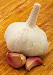 Garlic. head and cloves of purple garlic isolated on a wooden board