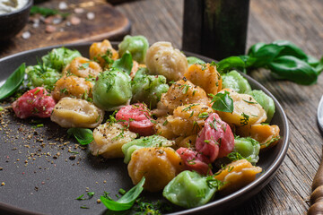 colorful dumplings in a bowl with sauce