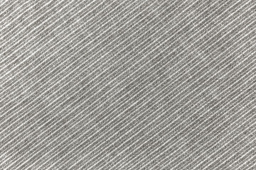 Natural linen texture as background. Cotton fabric with gray and white diagonal line striped pattern, texture close up. Backdrop, wallpaper. Matereal for clothes, curtain and upholstery