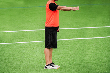 anonymous soccer referee in the middle of the soccer field