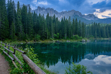 Cloudy twilight above the Lago di Carezza innthe Dolomites, Italy