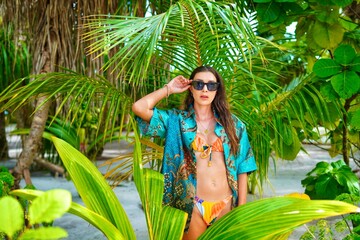 woman in bikini on the beach in the maldives, jungle shooting, portrait shooting 