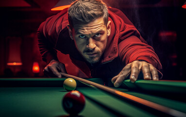 A billiard player is about to hit the ball with his cue.