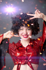 Festive smiling girl in an African American wig at a disco party.