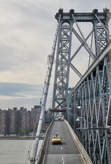 New York bridge with yellow taxi within the frame