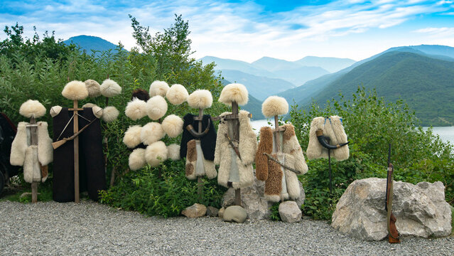 Georgian papakhas are sold to tourists against the backdrop of mountains. Journey along the military Georgian road.