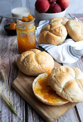 Buns with apricot jam. On a wooden table. Breakfast