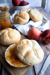 Buns with apricot jam. On a wooden table. Breakfast