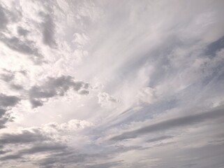Cirrus clouds and cirrostratus spread across the sky