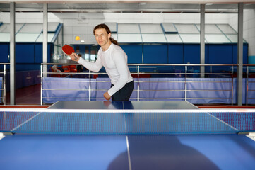 Young table tennis player training in sport club