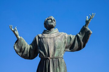 NAPLES, ITALY - APRIL 22, 2023: The bronze statue of St. Francis of Assisi near the church Basilica dell'Incoronata Madre del Buon Consiglio from 20. cent. - obrazy, fototapety, plakaty