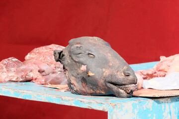 The head of a ram chopped off on the counter of the market. Lamb, meat for sale concept