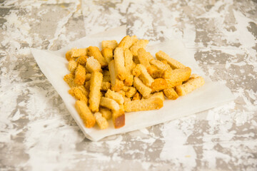 Fragrant salty crackers from rye bread on a light background. A tasty snack for beer.