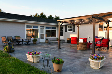 Patio living space with comfortable seating around fire pit under pergola - obrazy, fototapety, plakaty