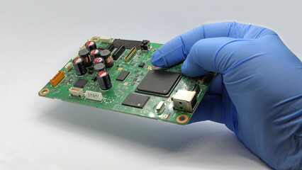 Electrical engineer holding a circuit board with microchips in his hand.  Standard marking of...