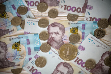 Bitcoin over the ukrainian hryvnia currency. Close up