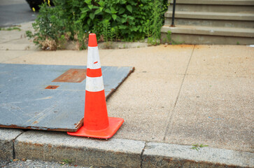bright orange construction cones arranged in a line, symbolizing safety, caution, and ongoing...