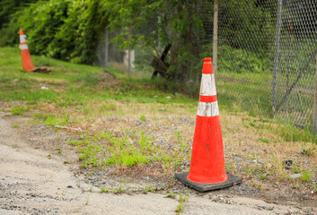 bright orange construction cones arranged in a line, symbolizing safety, caution, and ongoing...