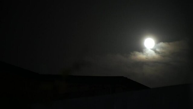 Full moon. Clouds pass in front of the moon