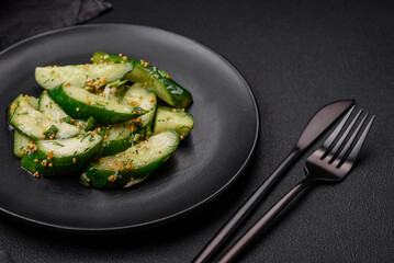 Delicious juicy cucumber cut into large slices with salt, spices and french mustard