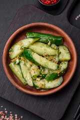 Delicious juicy cucumber cut into large slices with salt, spices and french mustard