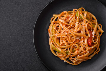 Delicious asian udon dish with vegetables, mushrooms, salt and spices