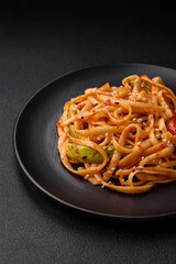 Delicious asian udon dish with vegetables, mushrooms, salt and spices