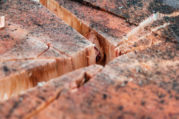 A cracked log and wood texture. Harvesting firewood with an axe in the village. Logs and timber on...