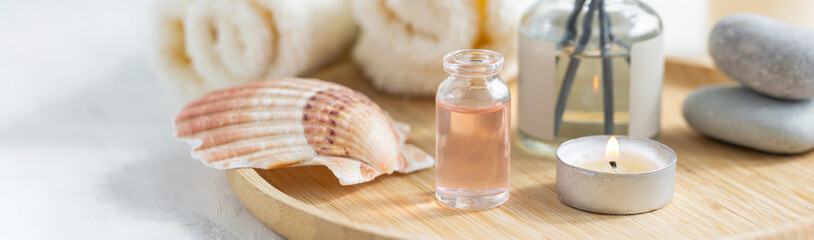 Concept of pure natural organic ingredients, flowers, herbal extracts in cosmetic beauty products. Perfumery, home fragrance with the scent of ocean fresh breeze. Candles, bamboo tray. Banner